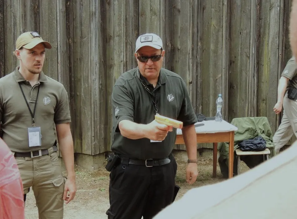Matt Temkin demonstrating point-shooting technique with a training pistol